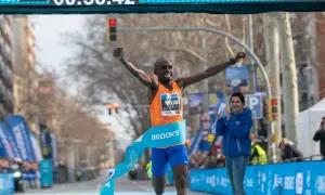 Atleta cruza la meta, celebrando su victoria y un posible récord de 1500 metros. El cronómetro marca 00:56:42.