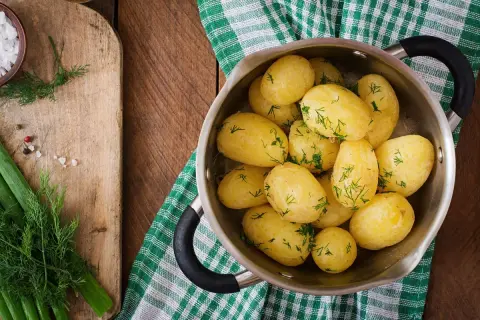 Patatas cocidas con eneldo en una olla. ¿Cuánto engorda la patata cocida? Depende de cómo la prepares.